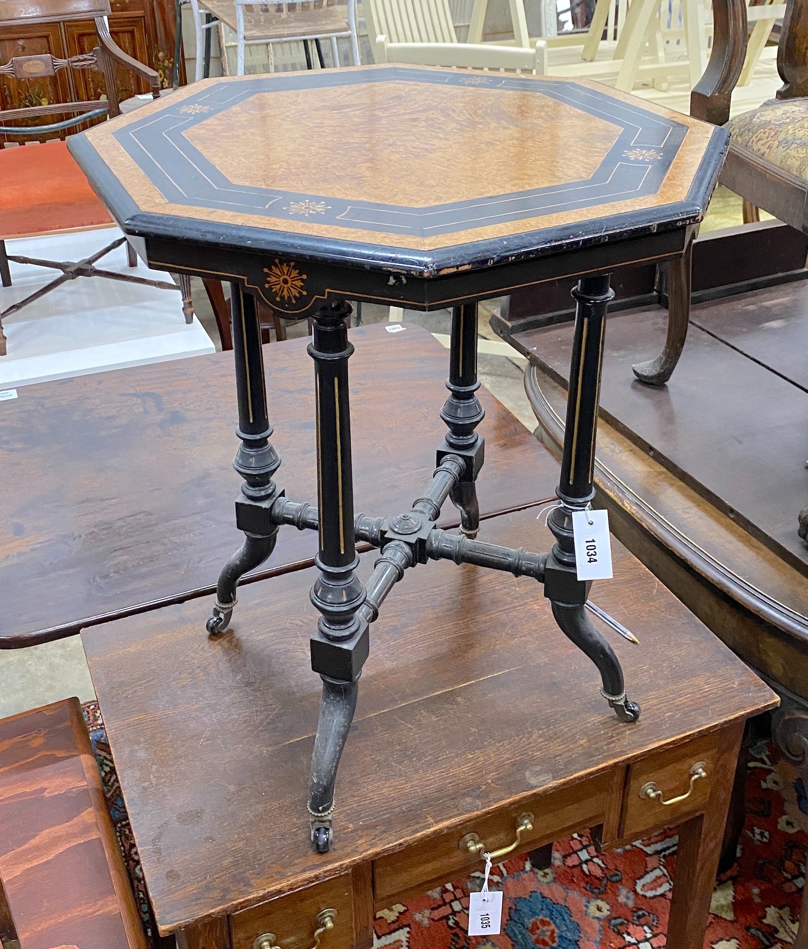A late Victorian ebonised and amboyna octagonal centre table, width 56cm, height 64cm